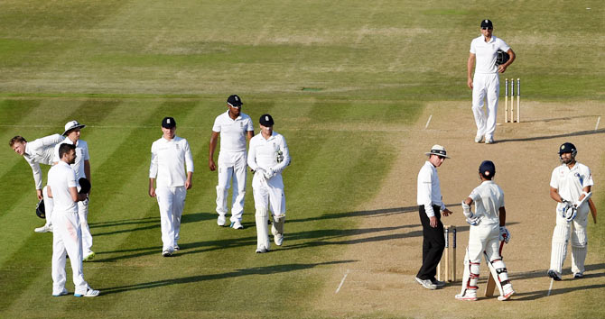 England bowler James Anderson (left) looks on as India batsman Ajinkya Rahane (2nd from right) talks to umpire Rod Tucker after play finishes on day four on Wednesday