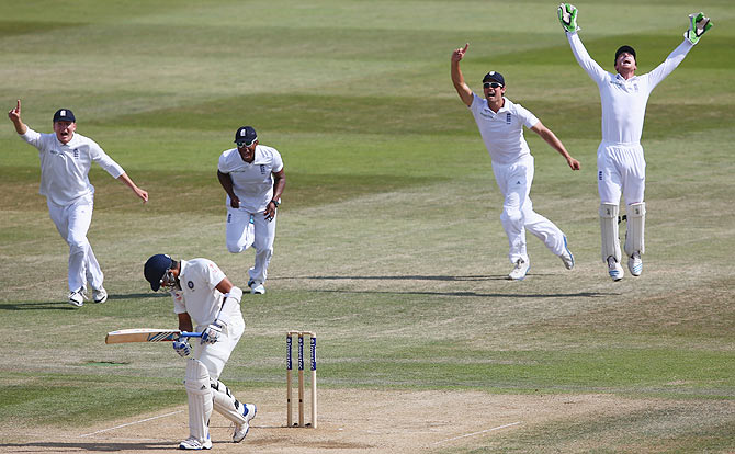 Jos Buttler (right) celebrates after taking a catch to dismiss Rohit Sharma off the bowling of James Anderson on Day 5 of the third Test at the Ageas Bowl in Southampton on Thursday