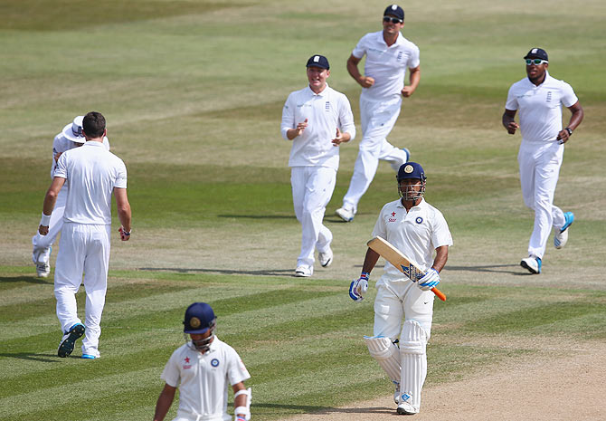 James Anderson (left) of England cerlebrates with teammates after dismissing Mahendra Singh Dhoni