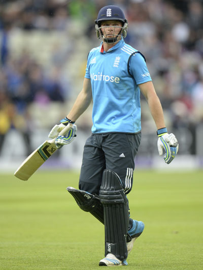 England's Jos Buttler leaves the field after declared being run-out.