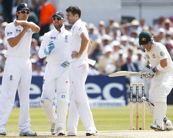 England's captain Alastair Cook signals for a television review.