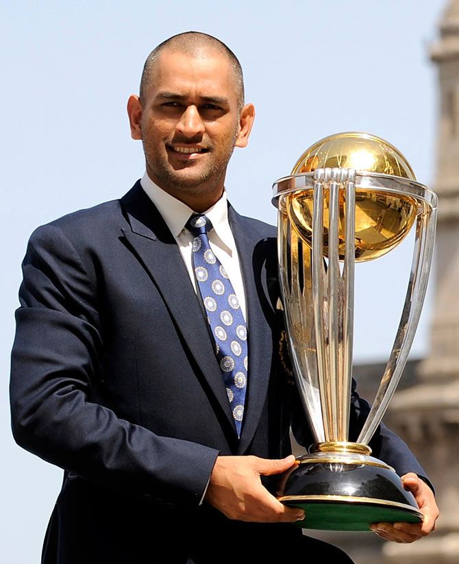 Captain Mahendra Singh Dhoni lifts the trophy at the Taj hotel the day after India defeated Sri Lanka in the ICC Cricket World Cup final in Mumbai on April 3, 2011