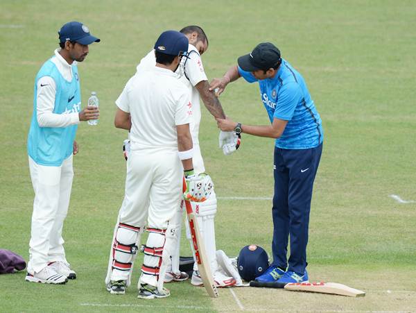 Shikhar Dhawan receives treatment after being hit on the arm by a delivery from Leicestershire's Atif Sheikh