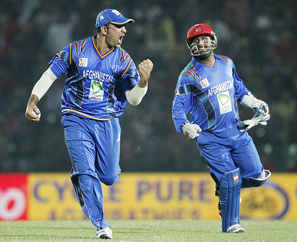 Afghanistan's Samiullah Shenwari (left) and wicketkeeper Mohammad Shahzad celebrate the dismissal of Bangladesh's Nasir Hossain on Saturday