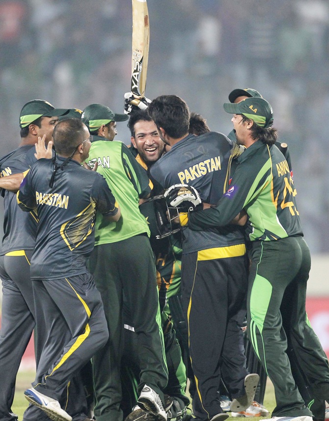 Pakistan's Shahid Afridi,right, celebrates with teammates after Pakistan won the match against India.