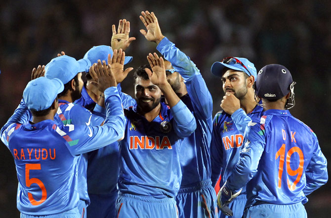 Team India celebrates the fall of a wicket