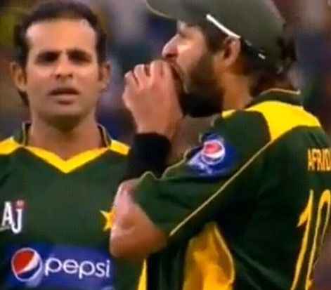 A television grab of Shahid Afridi biting the ball