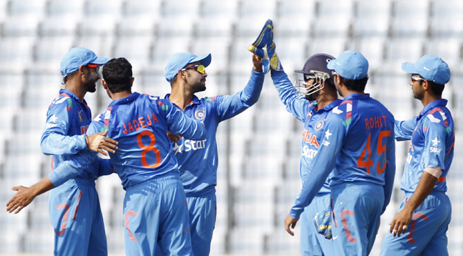Indian players celebrate after picking a wicket