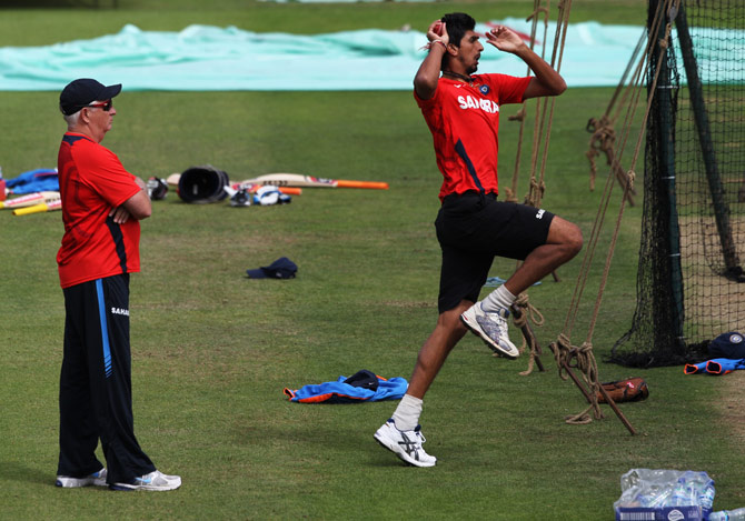Ishant Sharma bowls as coach Duncan Fletcher watches during a Team India nets session.