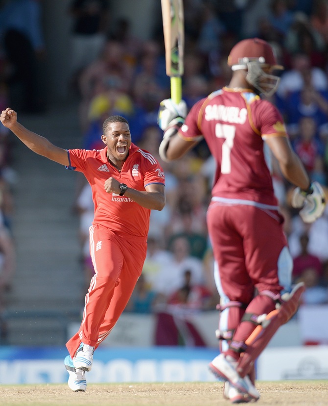 Chris Jordan of England celebrates with teammates after dismissing Johnson Charles of the West Indies