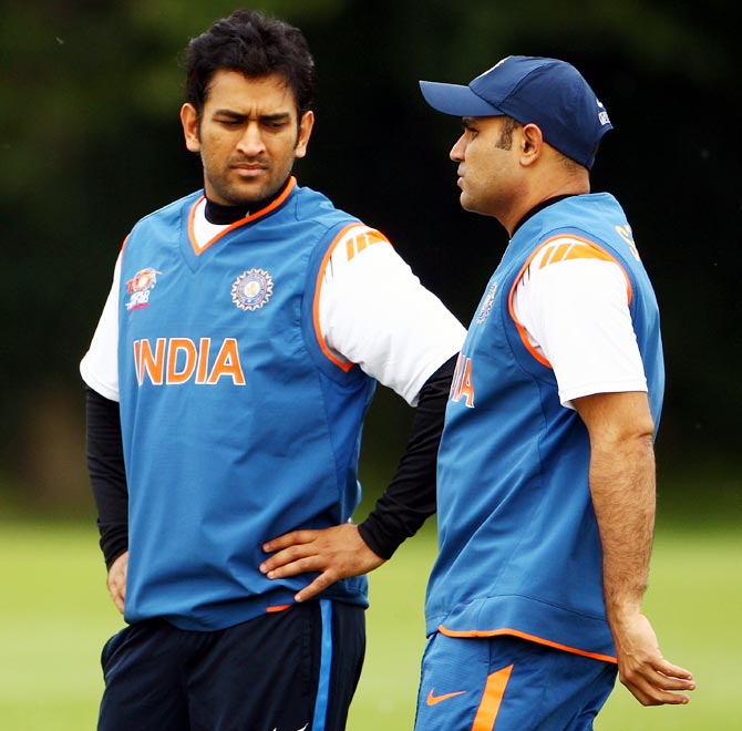 Virender Sehwag (right) speaks to India captain Mahendra Singh Dhoni