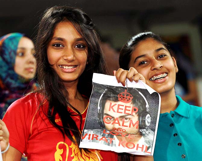 Young fans cheer for Virat Kohli during the IPL