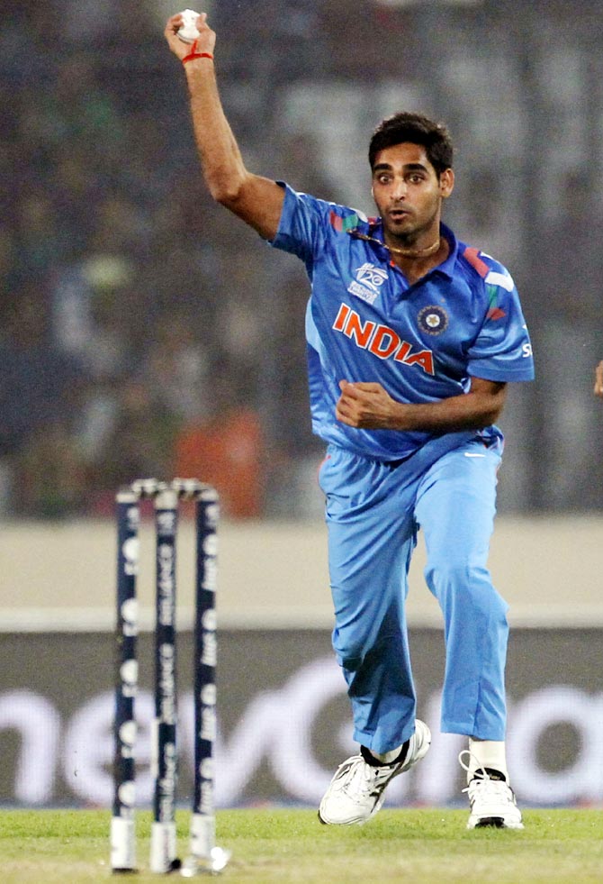 Bhuvneshwar Kumar throws the ball and break the wickets to dismiss Kamran Akmal in the ICC Twenty20 World Cup at the Sher-E-Bangla National Cricket Stadium in Dhaka