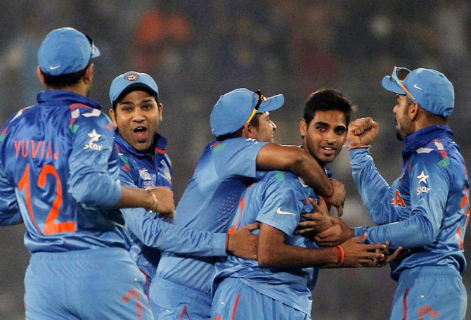 Bhuvneshwar Kumar (second from right) is congratulated by his teammates after catching Mohammad Hafeez