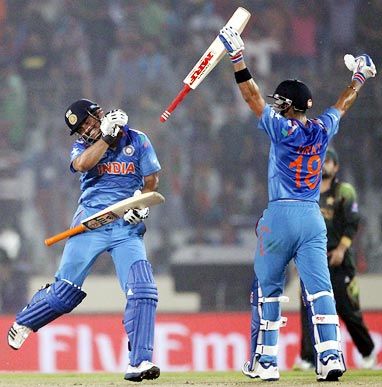 Virat Kohli (right) and Suresh Raina celebrate after overhauling Pakistan's total