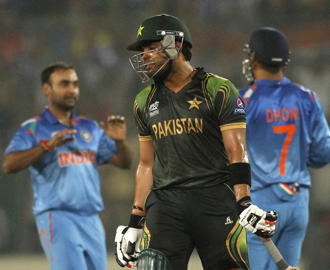 Pakistan's Umar Akmal reacts after teammate Shoaib Malik is dismissed by India's captain and wicketkeeper MS Dhoni
