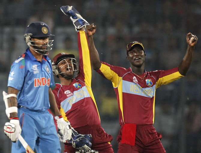 West Indies' wicketkeeper Andre Fletcher, centre, and captain   Darren Sammy,right, appeal for India's Shikhar Dhawan's dismissal successfully