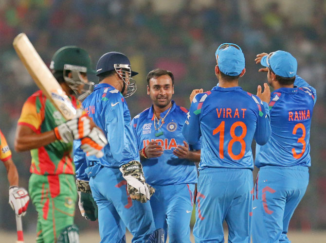Amit Mishra is congratulated by teammates after dismissing Anamul Haque