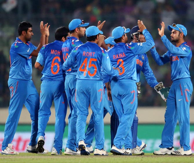 Indian players celebrate after Virat Kohli (right) takes a catch to dismiss Aaron Finch of Australia