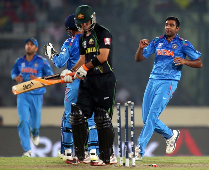 R Ashwin (right) celebrates after taking the wicket of Glenn Maxwell