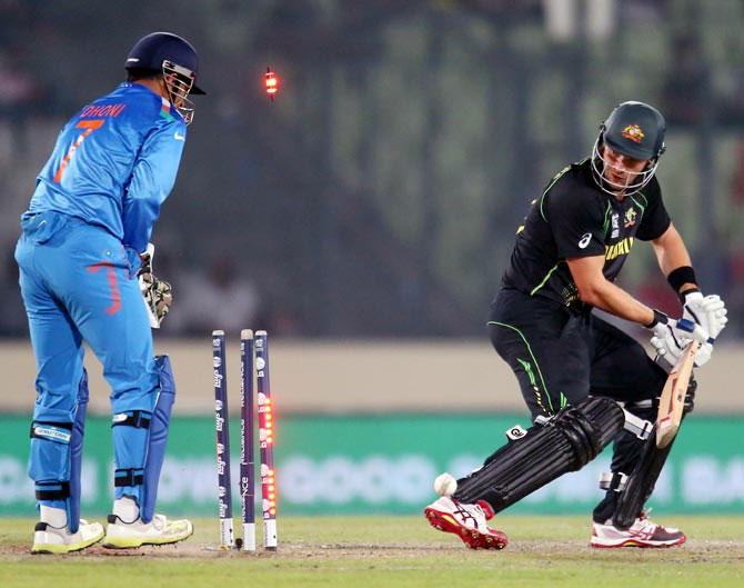 Shane Watson is bowled as Dhoni looks on