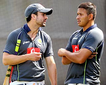 Ed Cowan (left) speaks to Usman Khawaja during a training session