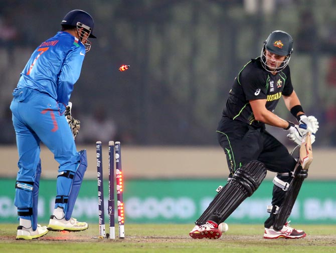 Shane Watson is bowled by Mohit Sharma as wicketkeeper Mahendra Singh Dhoni looks on.