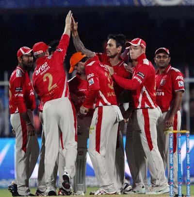 Kings XI Punjab players celebrate a dismissal by Mitchell Johnson