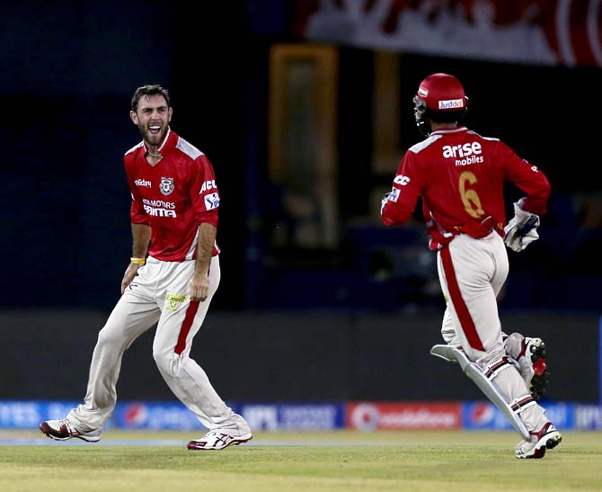 Glenn Maxwell (left) celebrates the wicket of Suresh Raina with team mate Wriddhiman Saha