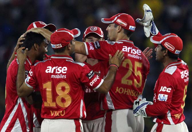Kings XI Punjab players celebrate a wicket against Chennai Super Kings