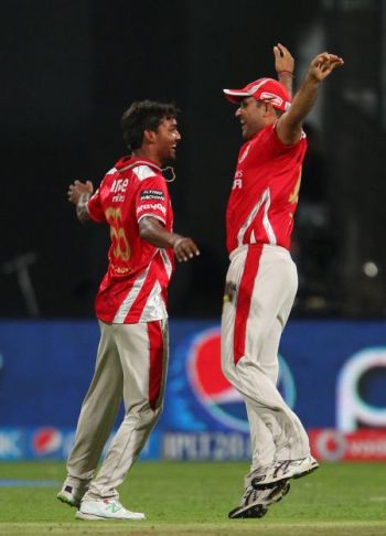 Sandeep Sharma and Virender Sehwag celebrate the fall of a wicket