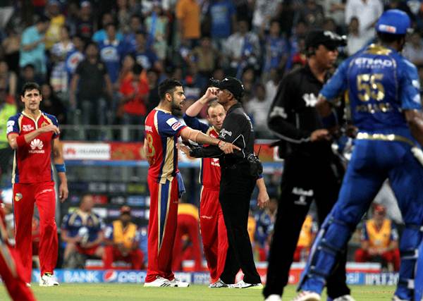 The umpires try to calm down players of both sides after the incident.
