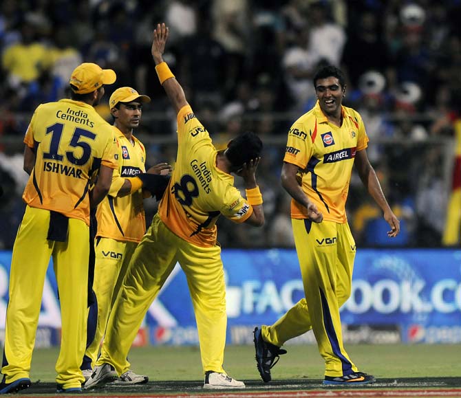 Ravichandran Ashwin (right) celebrates the wicket of Kieron Pollard with his team mates