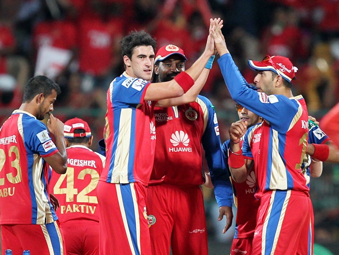 Mitchell Starc and Yuvraj Singh of the Royal Challengers Banglore celebrates wicket of Quinton de Kock of Delhi Daredevils