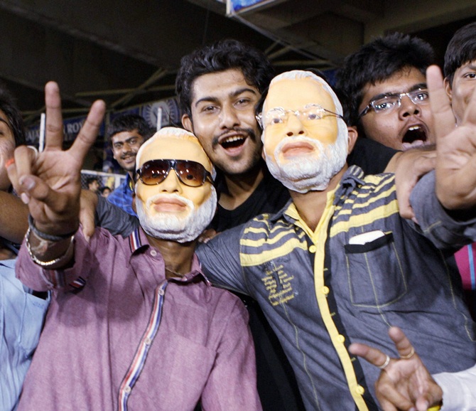 Fans wearing mask of Narendra Modi during an IPL-7 match