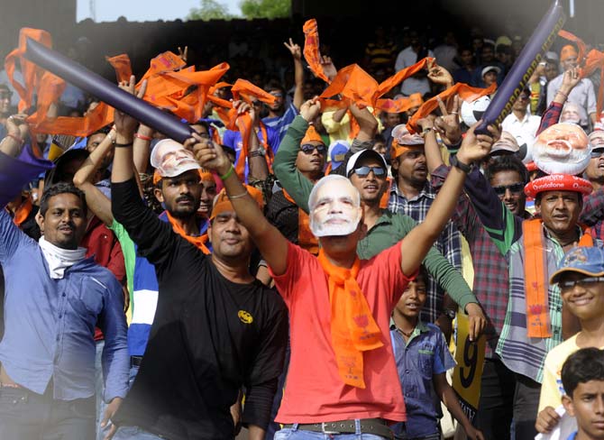 Fans wearing Narendra Modi masks at the IPL match between Rajasthan Royals and Kolkata Knight Riders in Ahmedabad.