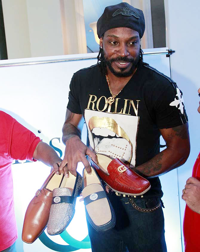 Chris Gayle displays his shoe designs at the launch event in Mumbai on Sunday