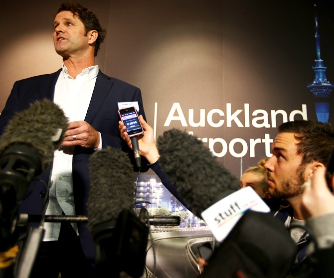 Chris Cairns reads a prepared statement to the media at a press conference at Auckland Airport.