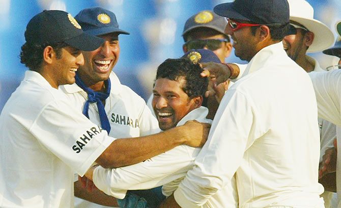 Sachin Tendulkar is congratulated by his teammates after dismissing Pakistani batsman Moin Khan on Day 3 of the 1st Test Match between Pakistan and India at Multan Stadium on March 30, 2004