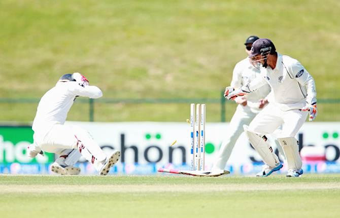 Ahmed Shehzad of Pakistan is hit on the head off a delivery from Corey Anderson of New Zealand during Day 2 of the first Test at the Sheikh Zayed stadium.