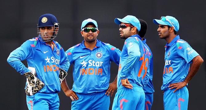 MS Dhoni, Suresh Raina, Virat Kohli and Bhuvneshwar Kumar of India look on