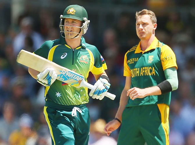 Dale Steyn of South Africa looks towards Michael Clarke of Australia as he runs between the wickets