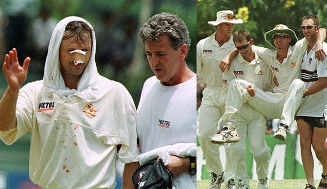 Australian captain Steve Waugh (left), with physiologist Errol Alcot, waves to the crowd before leaving the field after colliding with teammate Jason Gillespie in an attempt to take a catch to dismiss Sri Lankan batsman Mahela Jayawardena on the second day of the first Test at the Asgiriya stadium in central Kandy on September 10 1999. Australian fielder Jason Gillespie is carried off the field after colliding with Steve Waugh