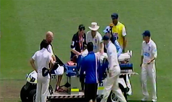 Phillip Hughes of South Australia lays on a stretcher after being struck in the head by a delivery 