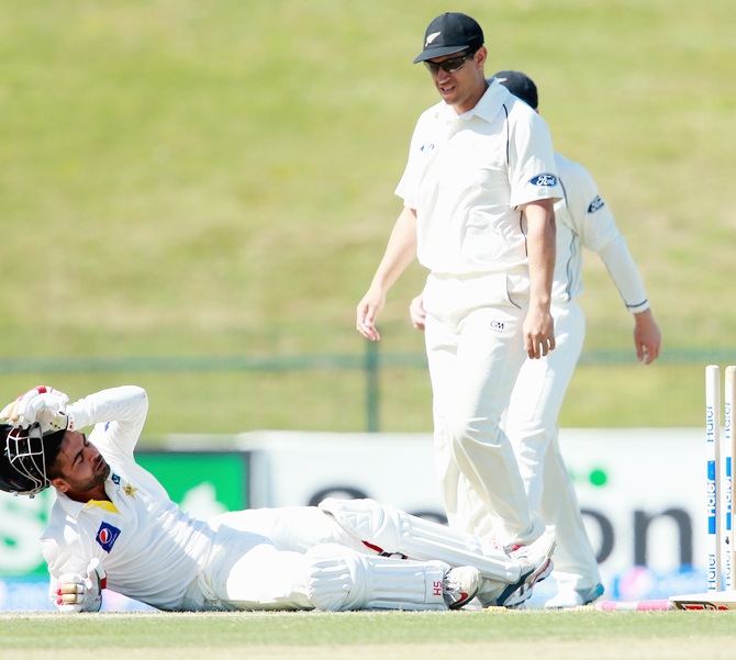 Ahmed Shehzad of Pakistan lies injured after hitting his wicket bowled by Corey Anderson of   New Zealand