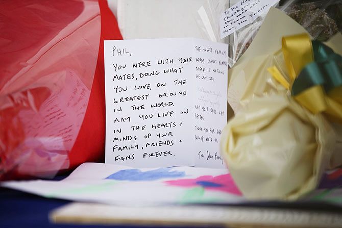 Flowers and condolence messages are left outside the Cricket New South Wales offices in Sydney on Friday after the death of cricketer Phil Hughes on Thursday