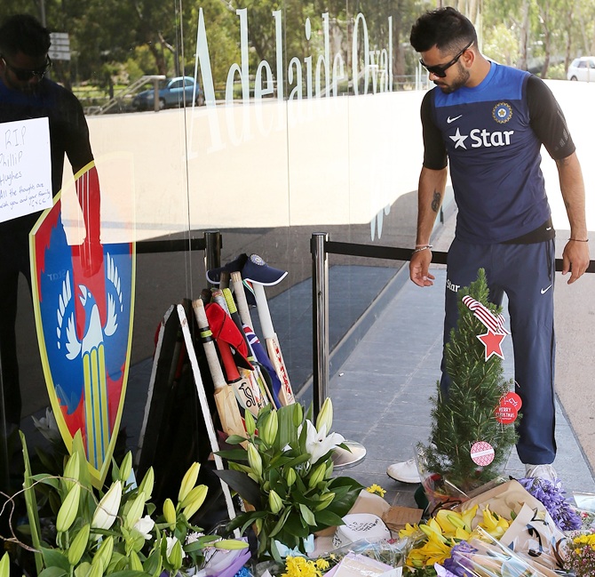 Virat Kohli of India leaves a bat and cap at a memorial for Phil Hughes 