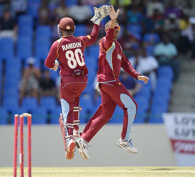 Sunil Narine of the West Indies celebrates with Denesh Ramdin 