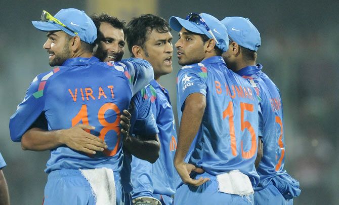 India cricketes Virat Kohli, Mohammad Shami, MS Dhoni and Bhuvaneshwar Kumar celebrate the fall of a West Indies wicket
