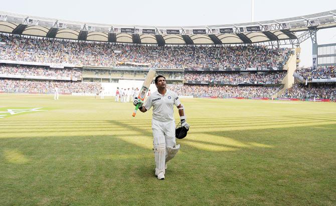 Sachin Tendulkar acknowledges the crowd as he walks back after his dismissal